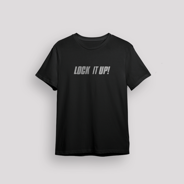 Flatlay of a black 100% cotton t-shirt from Beard and Hat Actor with the phrase “LOCK IT UP!” printed in light gray across the chest