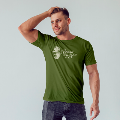 Male model wearing a military green 100% cotton t-shirt featuring the original Beard and Hat Actor logo printed in cream as a one-color chest design